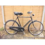 A 1950s Raleigh bicycle: black frame with frame mounted Sturmey Archer three speed gears,