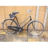 A Raleigh lady's bicycle: all steel step through black frame, Sturmey Archer three speed gears,