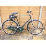 A 1950s Raleigh 'Superbe' Roadster bicycle: original green step frame with decals,