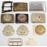 A group of foreign belt buckles and a reproduction German belt buckle: