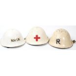 A post war National Health Service Reserve Mk III 'turtle' steel helmet: white with 'NHSR' to front,