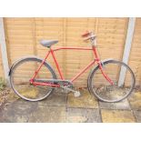 A GPO Armstrong bicycle: red frame with chrome handlebars and bar brakes,