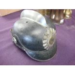 An early 20th century German black leather fire helmet by J R Lieb,