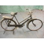 An early 20th century Sun bicycle: step through frame, plated handlebars, bar brakes, rear pannier,