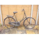 A 1930s Swift bicycle: step through frame, plated handlebars, bar brakes, black leather saddle,