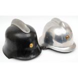 A German polished steel M35 pattern Fire Service helmet: of one piece construction with brass badge