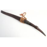 A 19th century Burmese Dha: the slightly curved blade with copper bound hilt and bird's head