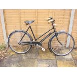 An early 20th century 'The Sun' bicycle: step through frame, black painted handlebars, bar brakes,