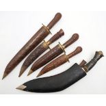 An ebony handled kukri in black leather scabbard,