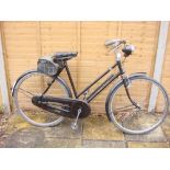 A Raleigh All Steel bicycle,: the black step through frame with red coach lines, plated handlebars,