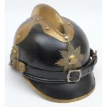An early 20th century German black leather fire helmet: the skull with attached gilt brass comb and