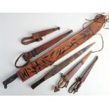 A Columbian Garza machete: with two piece wooden grip in a fringed leather scabbard,