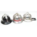 Three Austrian Fire Service aluminium helmets: all with six pointed comb and enamel badges to front,
