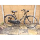 A 1914 Sunbeam lady's bicycle: the black step through frame with shaped bars and bar brakes,