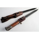 Two Czechoslovakian V224 pattern bayonets: both with two piece wooden grips in steel scabbards,
