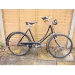 A 1930s Hercules lady's bicycle: black step through frame, solid bar brakes,