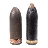 Two WWI artillery shells: one with brass fuse.