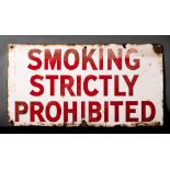 An enamel warning sign 'Smoking Strictly Prohibited': red text on a white ground,