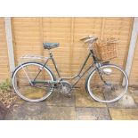 A 1960s BSA Shopper bicycle: green step through frame ,chrome plated handlebars, bar rakes,