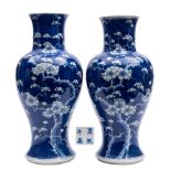 A matched pair of Chinese blue and white baluster vases: painted with prunus on a cracked ice