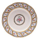 A Sevrès soup plate [assiette à potage]: painted with a central rose and cornflower medallion