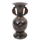 A large Chinese cloisonne vase: of ovoid form with flared rim, winged handles on a domed foot,