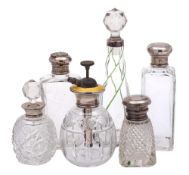 A mixed collection of clear glass and silver mounted dressing table jars: various makers and dates