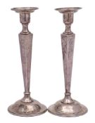 A pair of silver candlesticks, unmarked, possibly Canadian: initialled,