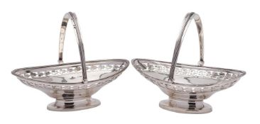 A pair of George V silver swing handled sweetmeat dishes, maker Cohen & Charles, Birmingham,
