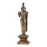A Sri Lankan solid-cast bronze standing figure of Buddha: with flame shaped crown,