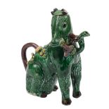 A Chinese egg and spinach glazed teapot and cover: in the form of a seated horse holding lingzhi