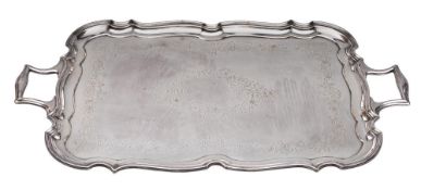 A large electro-plated serving tray: of cartouche-shaped outline with engraved foliate and scroll
