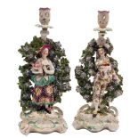 A pair of Derby bocage candlestick figures of the Italian Farmer and Wife: wearing colourful
