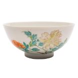 A Chinese famille rose bowl: the exterior enamelled with peony sprays and pierced blue rockwork,