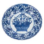 A Chinese blue and white 'basket of flowers' dish: painted with a central medallion of a large