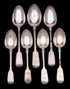 A collection of silver Fiddle pattern tablespoons and dessert spoons,