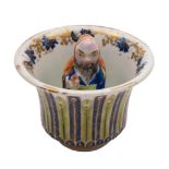 A Chinese famille rose 'trick' cup: the interior with a figure of the Immortal Han Zhongli and a