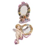 A small Meissen hanging mirror: in the form of a cherub and drapery supporting an oval flower