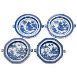 Two pairs of Chinese blue and white warming dishes: painted with lake views with pagodas and other