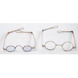 Two pairs of 19th century white metal spectacles:, one pair with lightly tinted oval lenses,