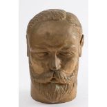 An early 20th century carved wooden bust of Edward VII: over painted in a gold colour, 17.5cm high.
