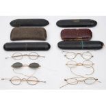 Six pairs of gold plated spectacles in cases: including a pair with tinted lenses.