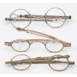 A pair of early 19th century silver spectacles: with clear oval lenses and extending frames ,