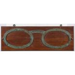 An early 20th century oak optician's shop sign: in the form of a pair of brass oval spectacle