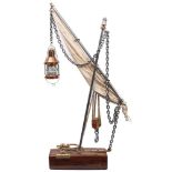 A nautical themed lamp: in the form of a mast and sail with copper ship's lantern suspended from