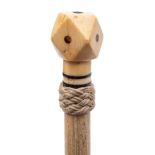 A 19th century marine ivory walking cane: the tetradecahedron pommel inset with tortoiseshell dots