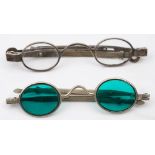 A pair of 19th century silver spectacles: with clear oval lenses and extendable arms,