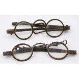 A pair of early 19th century paktong spectacles:, circular clear lenses and folding arms,