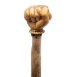 A 19th century marine ivory walking cane with carved pommel in the form of a fist holding a snake: