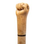 A 19th century marine ivory walking cane with carved pommel in the form of a fist: over a three